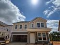 Two-story home with light and dark siding, visible windows, and an attached garage under construction at 776 Old Station Pointe, Angier, NC 27501