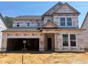 New home under construction featuring a classic two-story design and an attached two-car garage at 776 Old Station Pointe, Angier, NC 27501