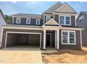 Two-story home showcasing a gray exterior, white trim, a two-car garage, and a well-defined roof line at 776 Old Station Pointe, Angier, NC 27501