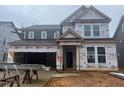 New two-story home featuring an attached two-car garage and covered entryway, still under construction at 776 Old Station Pointe, Angier, NC 27501