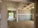 Spacious living room featuring coffered ceilings, a neutral color palette, and sliding glass doors to the outside at 776 Old Station Pointe, Angier, NC 27501