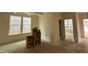 Bright living room featuring a trey ceiling, neutral walls, and ample natural light from the large window at 776 Old Station Pointe, Angier, NC 27501
