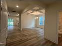 Bright, open-concept living room featuring hardwood floors and coffered ceiling at 776 Old Station Pointe, Angier, NC 27501