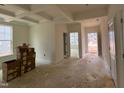 Bright living room featuring a trey ceiling, neutral walls, and ample natural light from the large window at 776 Old Station Pointe, Angier, NC 27501