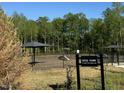 Dog park with multiple shade covers and agility equipment, designed exclusively for residents of Kensley Grove at 908 Kensley Grove Lane St #69, Fuquay Varina, NC 27526