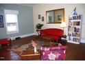 Cozy living room featuring hardwood floors, natural light, and vibrant red sofa at 1013 Green St, Durham, NC 27701