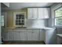 Kitchen featuring white cabinets, and a corner countertop, providing ample storage at 1015 Cross Link Rd, Raleigh, NC 27610