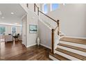 Elegant foyer with hardwood floors, wooden staircase, and high ceilings providing natural light at 1046 Covered Bridge Trl, Chapel Hill, NC 27517