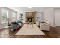 Cozy living room with a stone fireplace, plush rug, and ample seating at 1046 Covered Bridge Trl, Chapel Hill, NC 27517