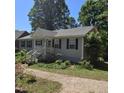 Well maintained one-story house, gray siding, black shutters, front yard with stone driveway at 106 Palomino Cv, Louisburg, NC 27549