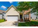 Inviting two-story home featuring a combination of siding and brick, with a two-car garage and manicured front lawn at 11 Piccadilly Ct, Durham, NC 27713