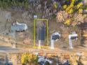 Aerial view showcasing property lines, house, road, and surrounding trees at 1101 Ridge Rd, Roxboro, NC 27573