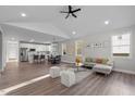Spacious open-concept living area with sleek hardwood floors, gray sofa, and modern finishes at 1101 Ridge Rd, Roxboro, NC 27573