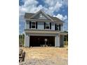 A new construction home featuring light blue siding and an attached two-car garage on a sunny day at 1105 Shovelhead Dr # 40, Durham, NC 27703