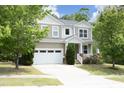 Charming two-story home featuring a two-car garage, front porch, and nicely landscaped front yard at 1106 Red Crest Ln, Durham, NC 27704