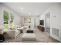 Bright living room features a comfortable white sectional, wood floors, and modern decor at 112 Carmichael Ct, Cary, NC 27511