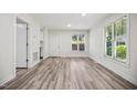 Cozy living room with luxury vinyl plank flooring, bright natural light, and white walls at 112 Carmichael Ct, Cary, NC 27511
