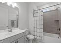 Clean bathroom with a shower-tub combo, contemporary vanity, and neutral color palette at 116 Alumroot Rd, Holly Springs, NC 27540