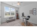 Cozy home office with a large window providing natural light, complemented by neutral decor at 116 Alumroot Rd, Holly Springs, NC 27540