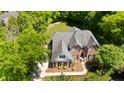 Aerial view of a beautiful red brick two-story home with a well-manicured lawn and mature trees at 1258 Jamestowne Dr, Elon, NC 27244