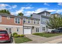 Street view of townhouses with neat lawns, one-car garages, and car parked in driveway at 127 Deacon Ridge St, Wake Forest, NC 27587