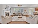 Comfortable living room with fireplace, large windows, and ample seating at 201 Bog Hill Ln, Cary, NC 27519
