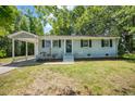 Charming single-story home featuring a covered front porch and well-maintained landscaping at 2108 Laurel Mill Centerville Rd, Louisburg, NC 27549