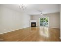 Spacious living room with fireplace, ceiling fan, and sliding doors to the outside at 2207 Bankshill Row, Raleigh, NC 27614