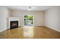 Bright living room featuring a fireplace, sliding door, and wood-look floors at 2207 Bankshill Row, Raleigh, NC 27614