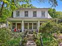 Charming two-story home with a inviting front porch and beautifully landscaped front yard in a neighborhood setting at 224 E Park Dr, Raleigh, NC 27605