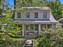 Inviting home featuring a covered front porch perfect for relaxing and enjoying the beautifully landscaped surroundings at 224 E Park Dr, Raleigh, NC 27605