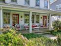 Cozy front porch furnished with wicker seating, ideal for enjoying the outdoors in style at 224 E Park Dr, Raleigh, NC 27605
