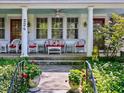 Inviting front porch with cozy wicker furniture, perfect for relaxing and enjoying the neighborhood views at 224 E Park Dr, Raleigh, NC 27605