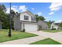 Modern two-story home featuring gray siding, a two-car garage, and a well-manicured front lawn at 230 Purple Aster St St, Youngsville, NC 27596