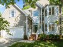 Attractive exterior of a home with brick stairs, white trim, and a well-maintained front yard at 2309 Clerestory Pl, Raleigh, NC 27615
