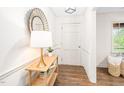 Bright entryway featuring fresh paint, hardwood floors, a decorative mirror, and modern decor at 2509 Elderwood Ln, Burlington, NC 27215
