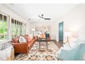 Cozy living room featuring hardwood floors, stylish furnishings, a ceiling fan, and an abundance of natural light at 2509 Elderwood Ln, Burlington, NC 27215