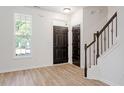 Bright foyer with beautiful flooring, staircase with decorative wrought iron spindles, and natural light at 274 Tuscarora Ln, Clayton, NC 27520