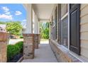 View of the brick and column-lined front porch with black shutters accenting the exterior at 274 Tuscarora Ln, Clayton, NC 27520