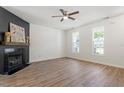 Inviting living room features wood-look flooring, a fireplace, and bright windows at 274 Tuscarora Ln, Clayton, NC 27520
