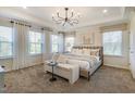 Spacious main bedroom featuring many windows, tray ceilings, and neutral color palette at 2771 Cassius Dr, Apex, NC 27502