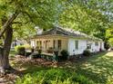 Quaint home with a covered front porch and mature shade trees at 301 N West St St, Cary, NC 27513