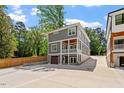 View of the backyard with concrete, exterior of house, fenced yard, and green trees at 3932 Old Chapel Hill Rd, Durham, NC 27707
