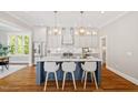 Modern kitchen with a spacious island, stainless steel appliances, and pendant lighting at 3932 Old Chapel Hill Rd, Durham, NC 27707
