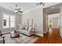 Bright living room with hardwood floors, neutral decor, and large windows at 3932 Old Chapel Hill Rd, Durham, NC 27707