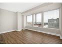 Spacious bedroom with hardwood floors and large windows offering city views at 400 W North St # 814, Raleigh, NC 27603