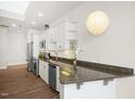 Bright kitchen featuring stainless steel appliances, granite countertops and ample white cabinetry at 400 W North St # 814, Raleigh, NC 27603