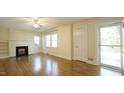 Comfortable living room featuring hardwood floors and a fireplace with white mantel at 409 Green St, Sanford, NC 27330