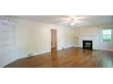Spacious living room featuring gleaming hardwood floors and a cozy fireplace at 409 Green St, Sanford, NC 27330