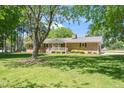 Charming brick house with a cozy front porch and a lush green lawn at 4418 Carpenter Pond Rd, Durham, NC 27703